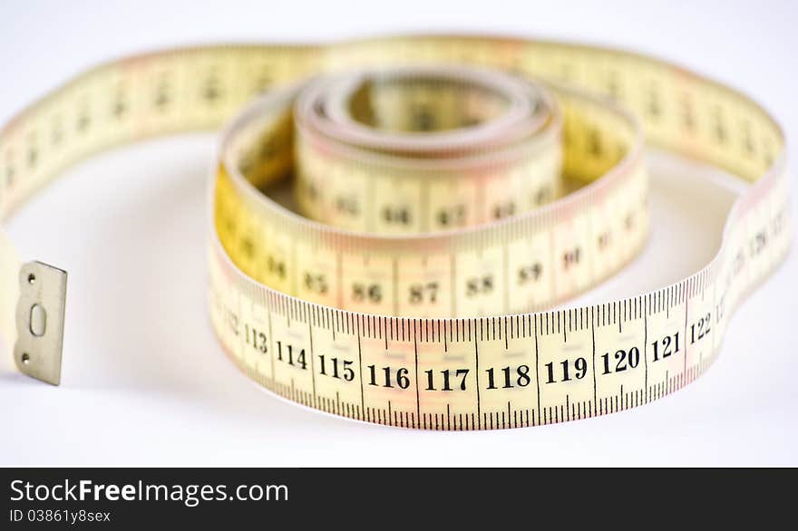 A yellow measuring tape on white background. A yellow measuring tape on white background