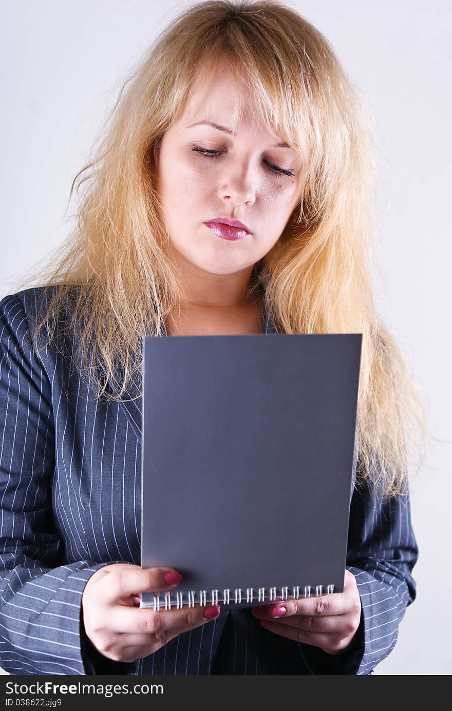 Girl reading a notebook on white