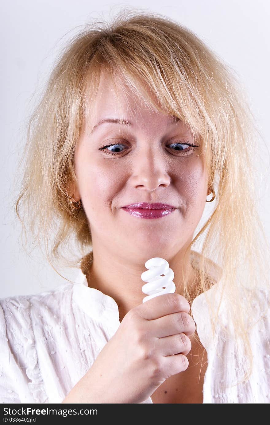 Beautiful blonde girl with a lamp in his hand.