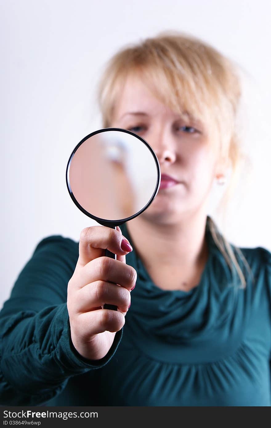 Young girl looking through magnifying glass