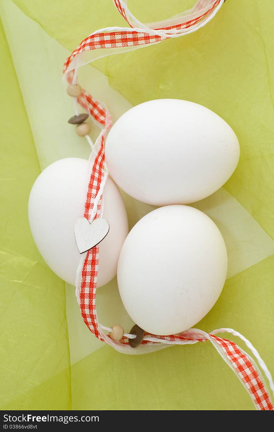 Still-life with eggs on a green background