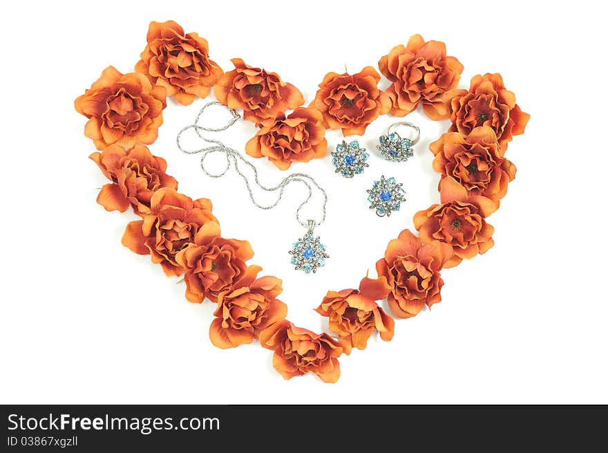 Beautiful jewelry set and  flowers around in heart shape. Beautiful jewelry set and  flowers around in heart shape