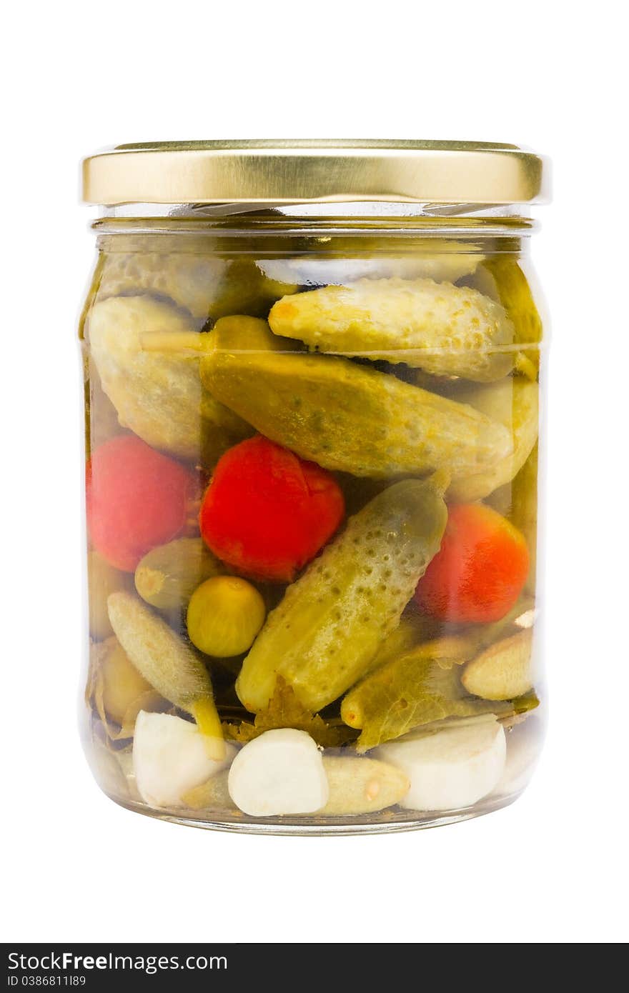 Preserved cucumbers and tomatoes, glass jar with pickled vegetables