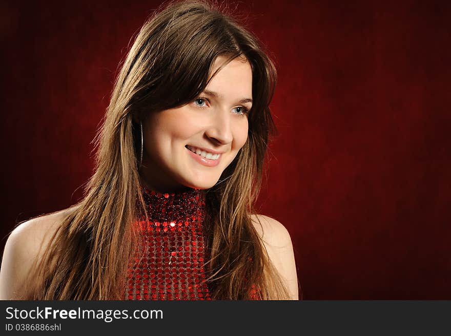 Portrait of the beautiful woman on a red background