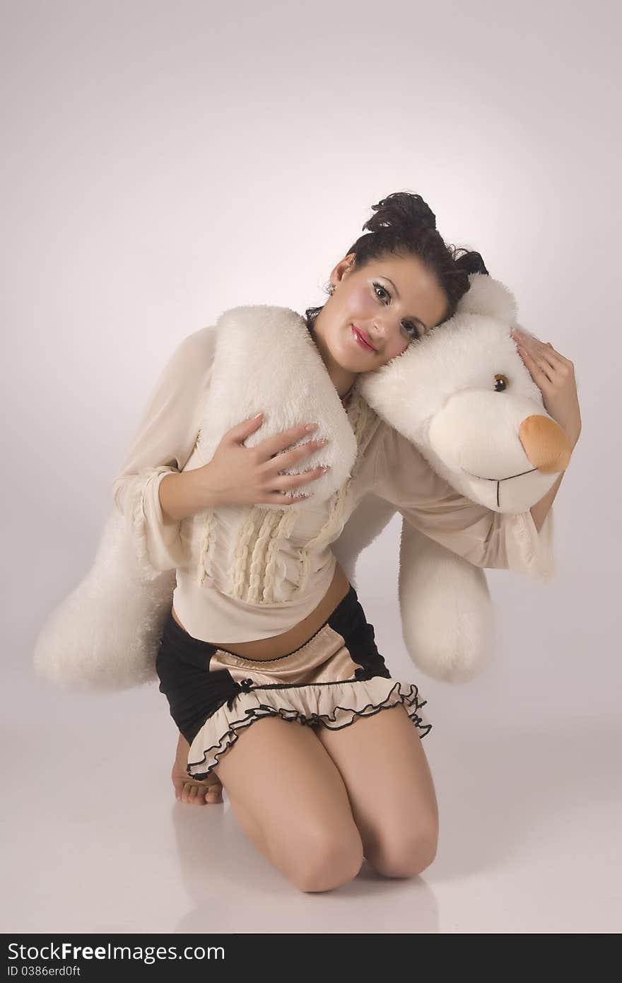 The beautiful model with a bear in hands