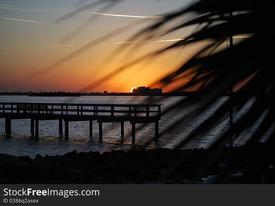 Golden sunset with blue sky and dock