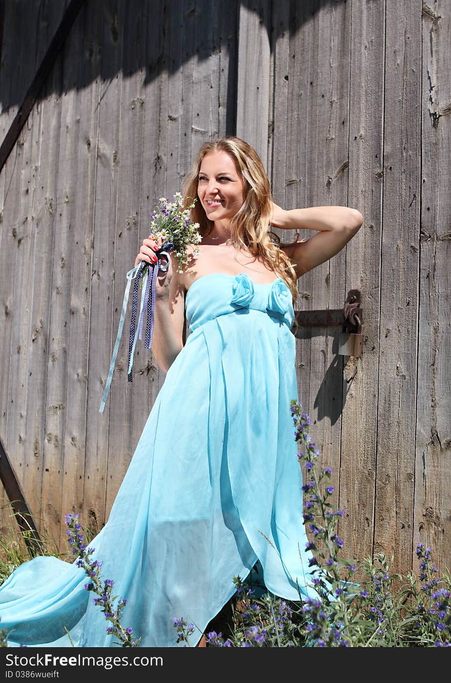 Blond girl in the blue dress in the summer day. Blond girl in the blue dress in the summer day