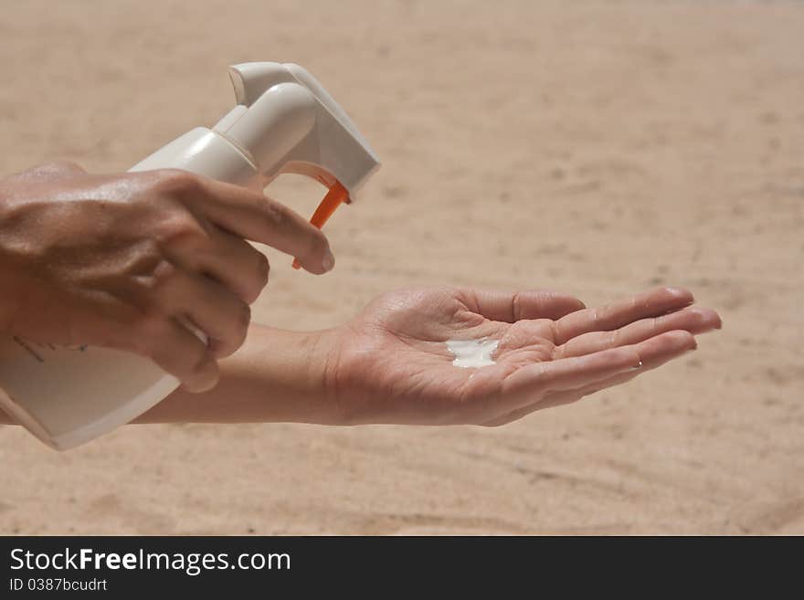 Bottle with tanner on the beach