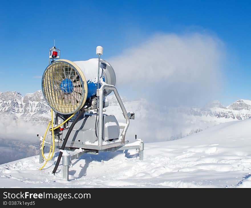 Snow cannon producing snow in the swiss alps