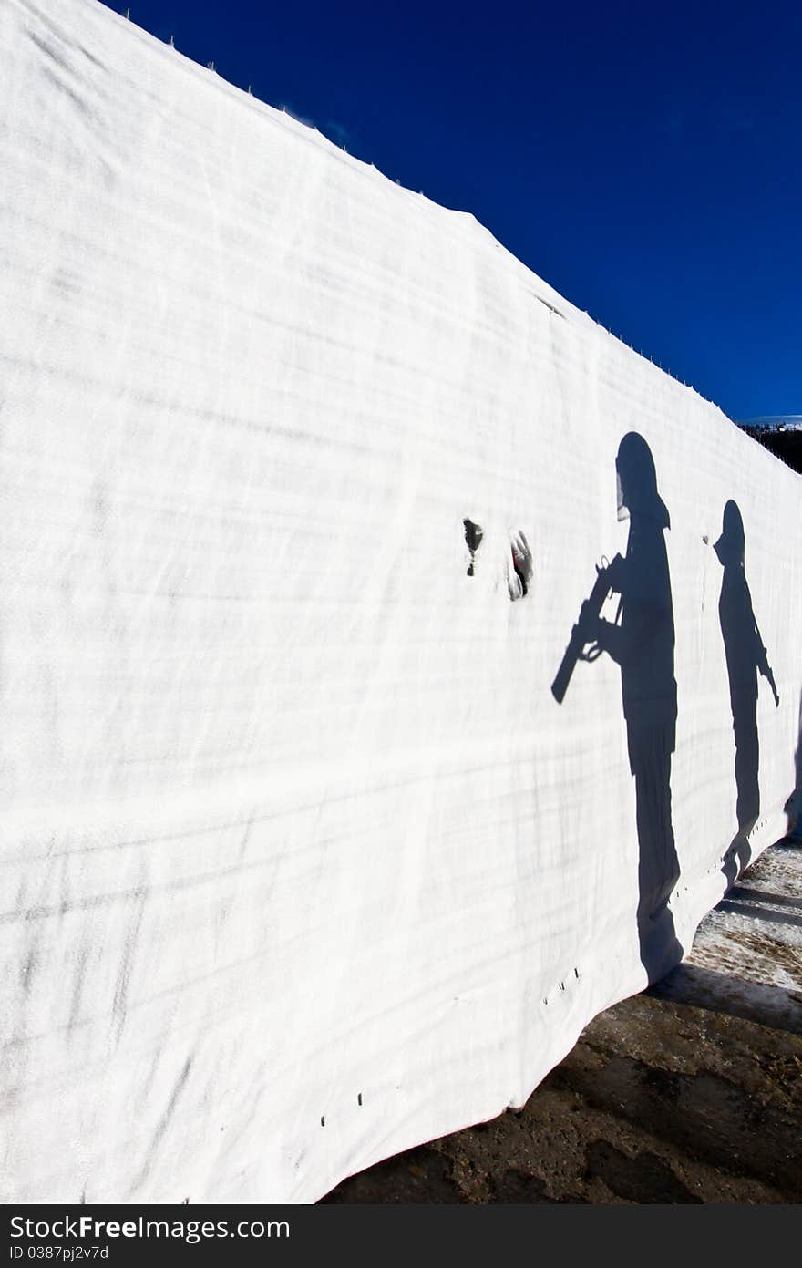 Two Security Man are standing in the sun with Weapons