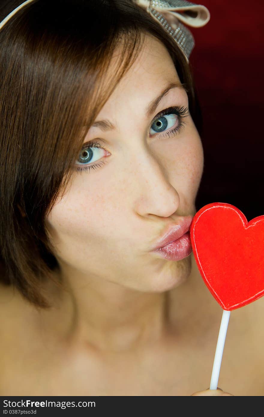 Female portrait with heart candy. Female portrait with heart candy