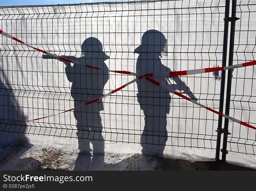 Two Policeman with Guns in the Shade of the sun