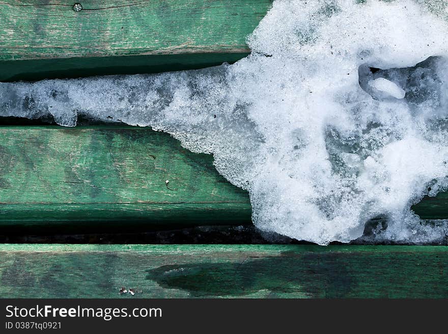 Texture of ice melting on green wood boards. Texture of ice melting on green wood boards.