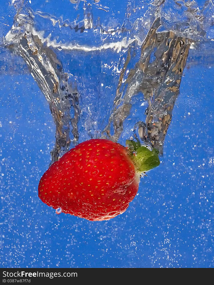 Strawberry splash on blue background