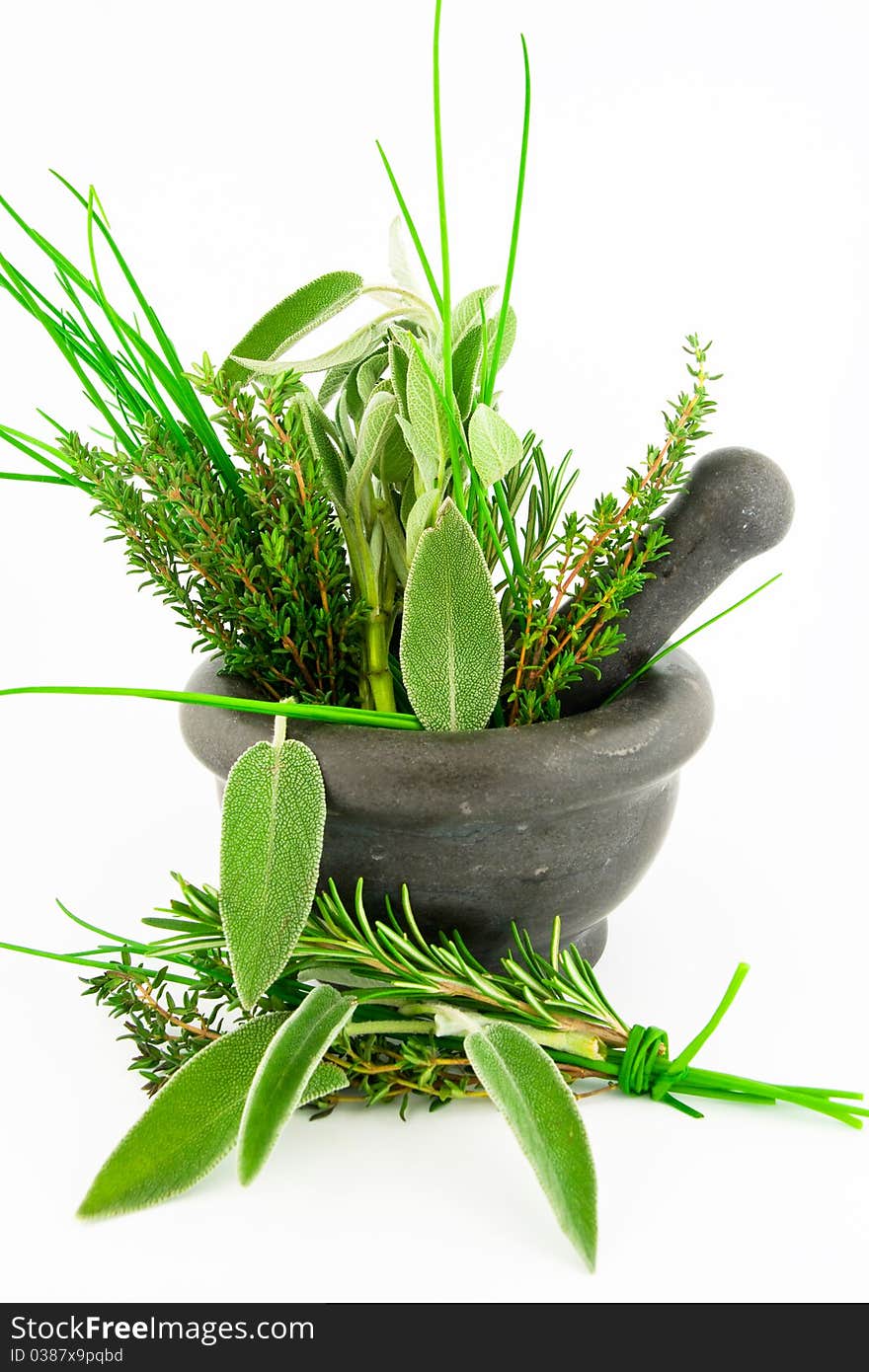 Marble pestle and mortar with a wide variety of herbs