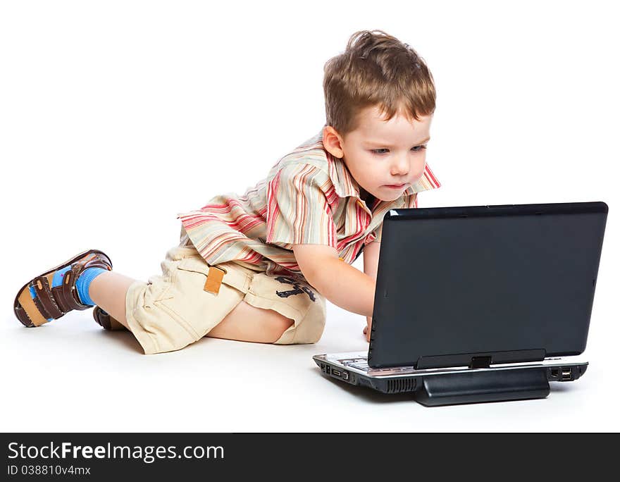 A cute boy is typing on a laptop. isolated on a white background