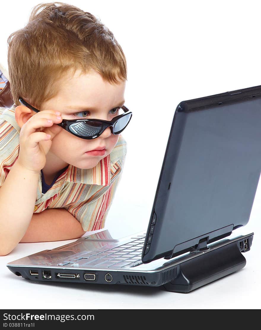 A cute boy is typing on a laptop. isolated on a white background