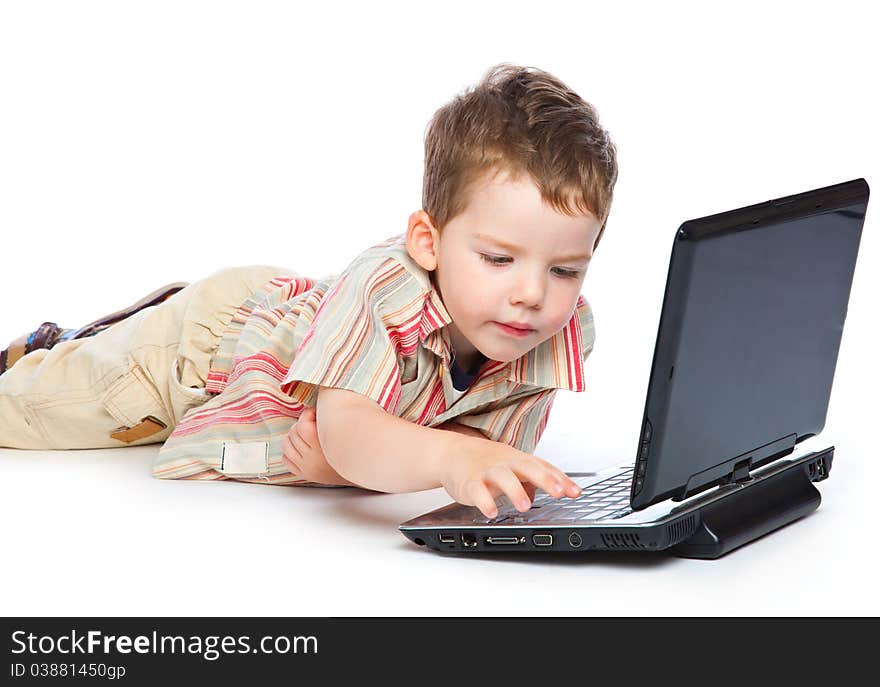 A cute boy is typing on a laptop. isolated on a white background