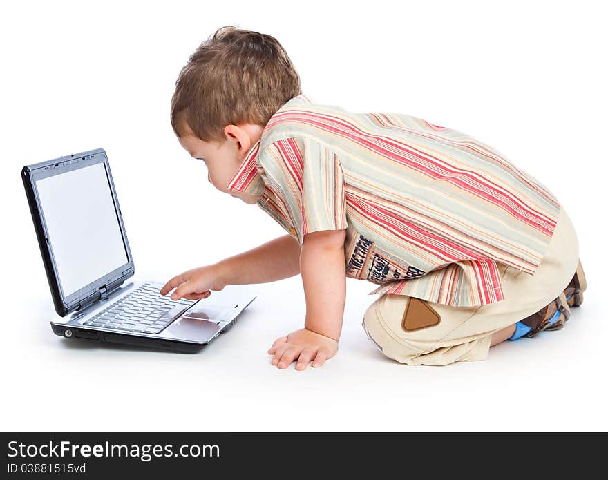 A cute boy is typing on a laptop. isolated on a white background