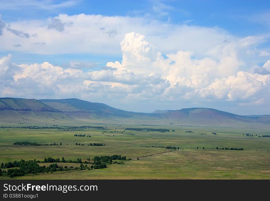 Green field and mountain in summer