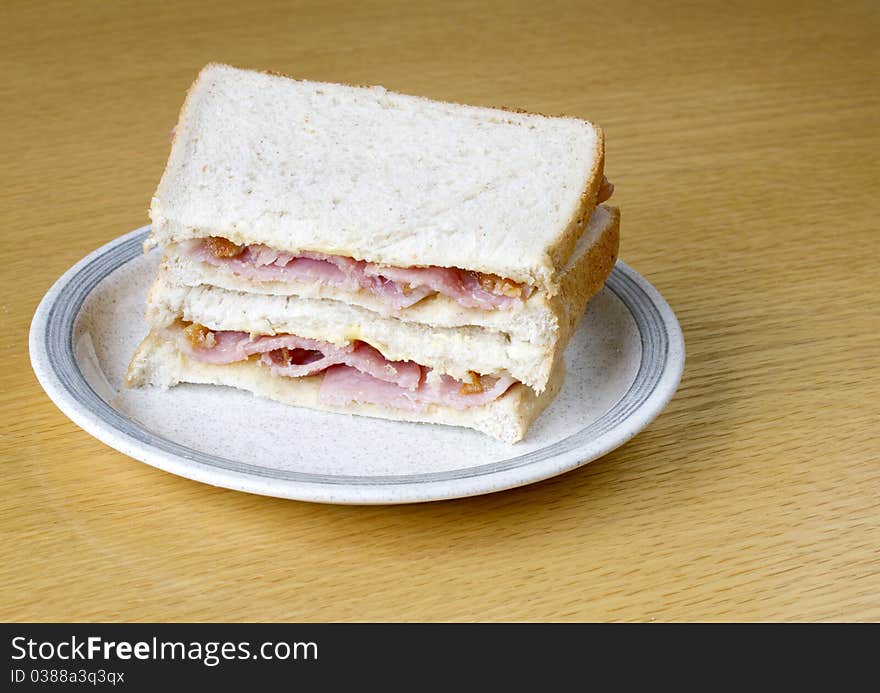 Two bacon sandwiches on a plate