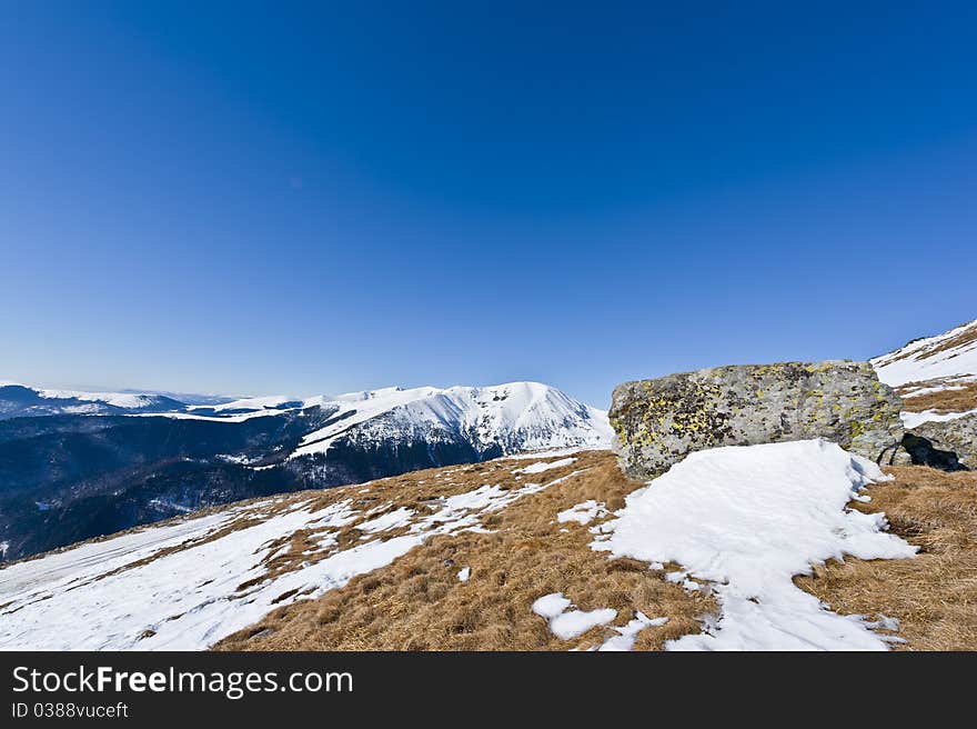 Mountain landscape with rocks in the foreground