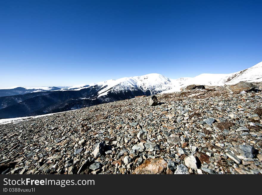 Mountain landscape with rocks in the foreground