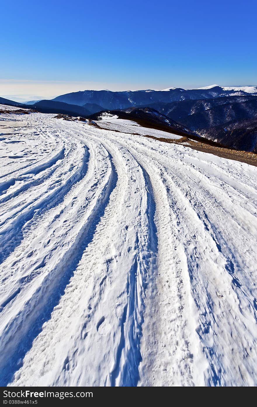 Winter landscape with a mountain ridge road