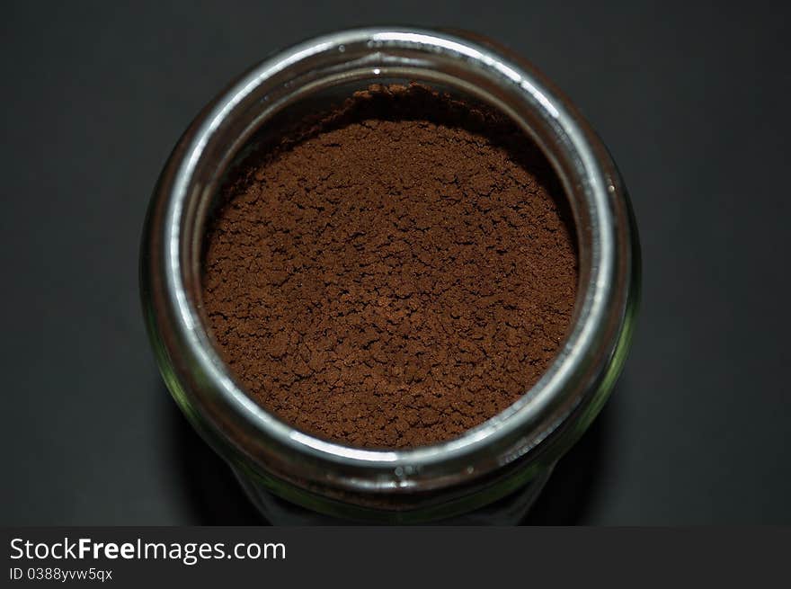 Close up shoot of a soluble coffee glass jar, focusing on the powder to show its texture. Close up shoot of a soluble coffee glass jar, focusing on the powder to show its texture.