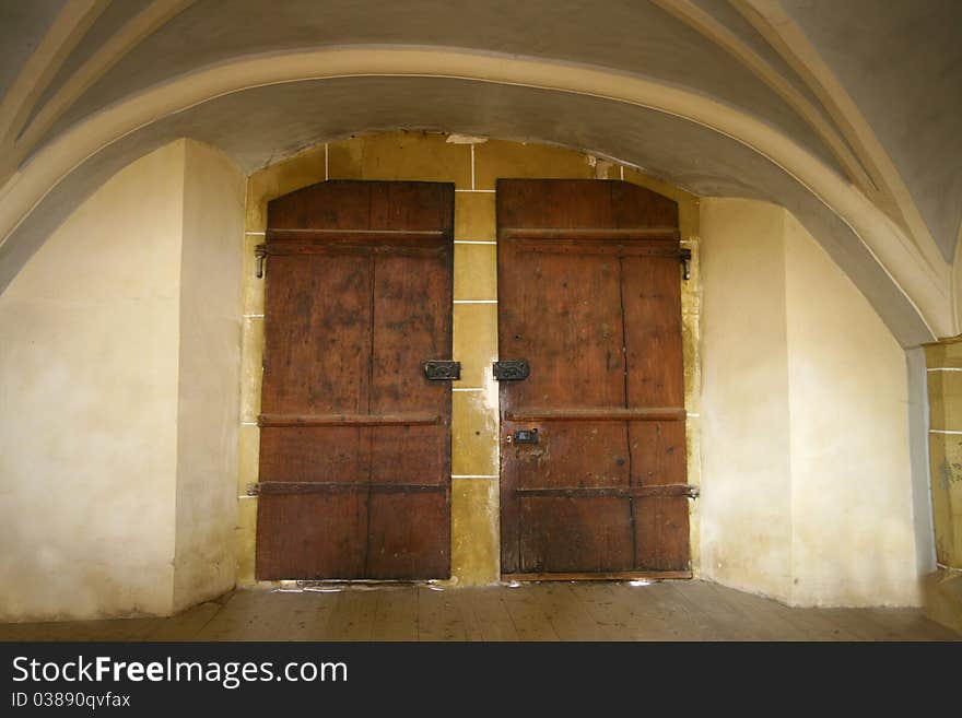 Old dark double door. Medieval church entrance.