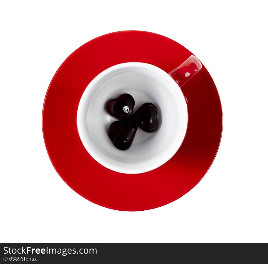 Red cup on the saucer with hearts on white