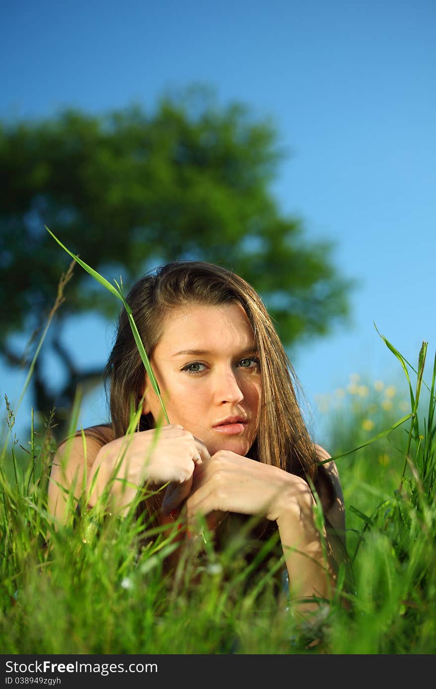 Brunette lays under the tree. Brunette lays under the tree