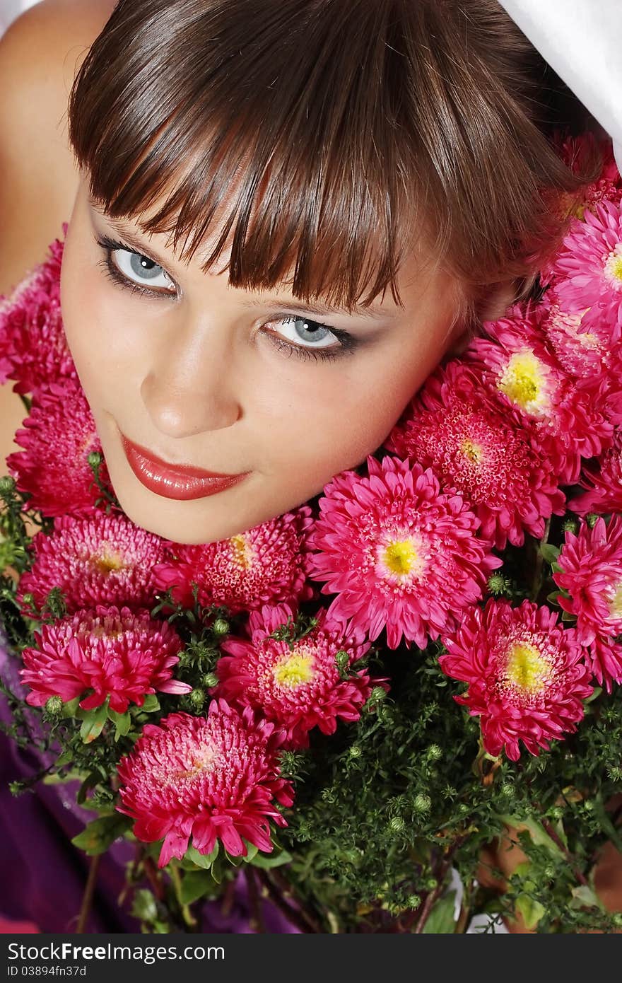 Portrait of a young woman with pink flowers. Portrait of a young woman with pink flowers