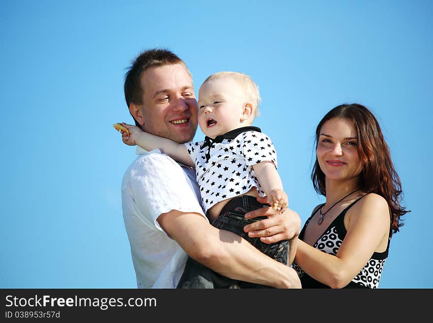 Happy family on blue sky background. Happy family on blue sky background