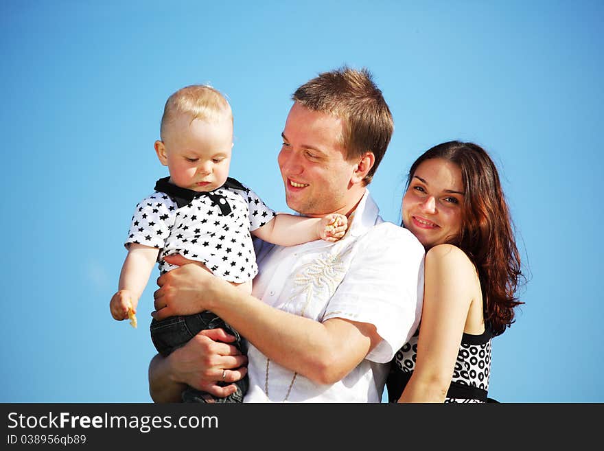 Happy family on blue sky background. Happy family on blue sky background