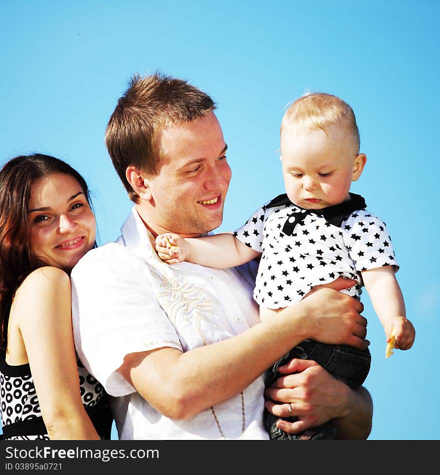 Happy family on blue sky background. Happy family on blue sky background