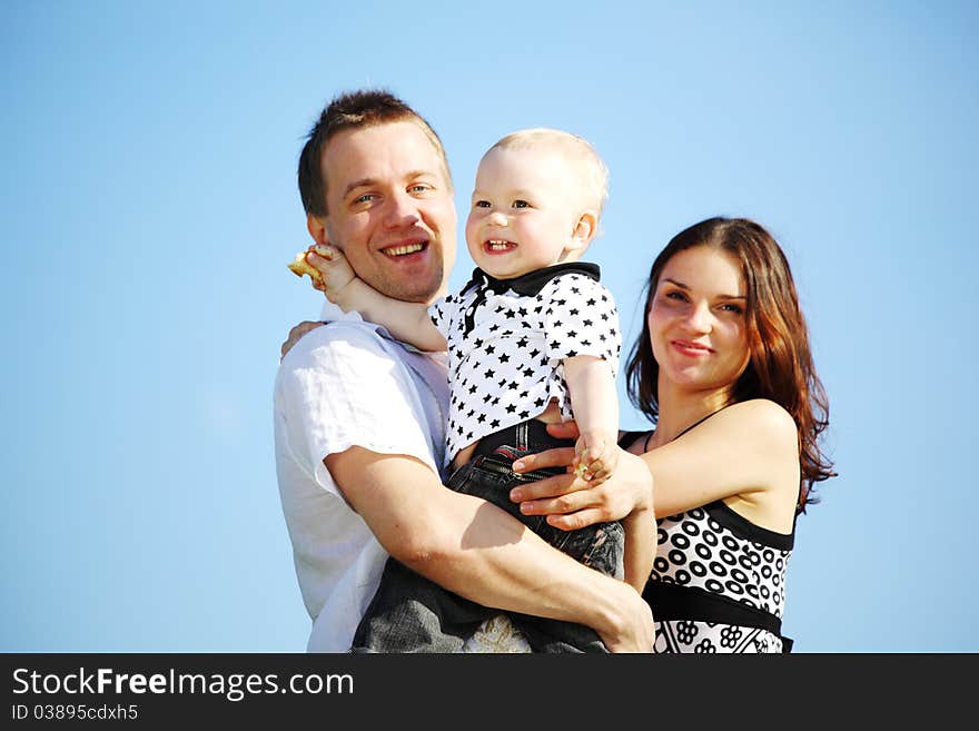 Happy family on blue sky background. Happy family on blue sky background