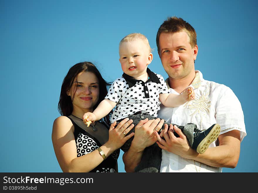 Happy family on blue sky background. Happy family on blue sky background