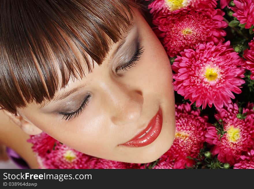 Portrait of a young woman with pink flowers. Portrait of a young woman with pink flowers