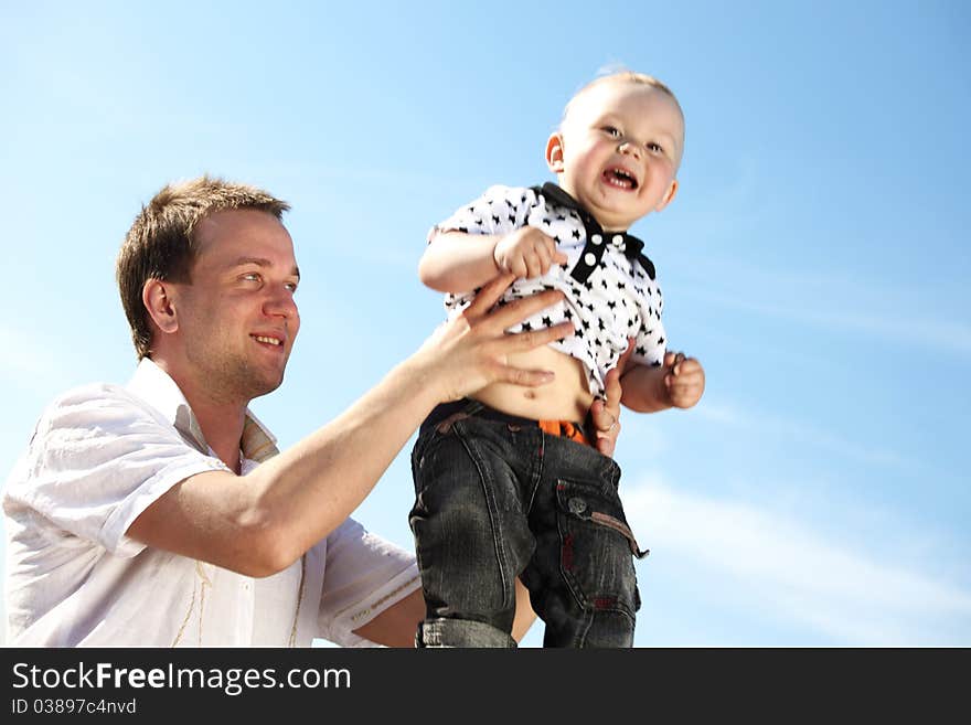 Father and take son in blue sky. Father and take son in blue sky