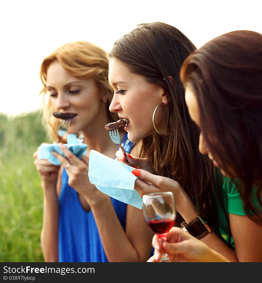 Girls drink wine on nature background. Girls drink wine on nature background