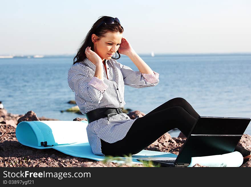 Woman work on laptop sea on background. Woman work on laptop sea on background