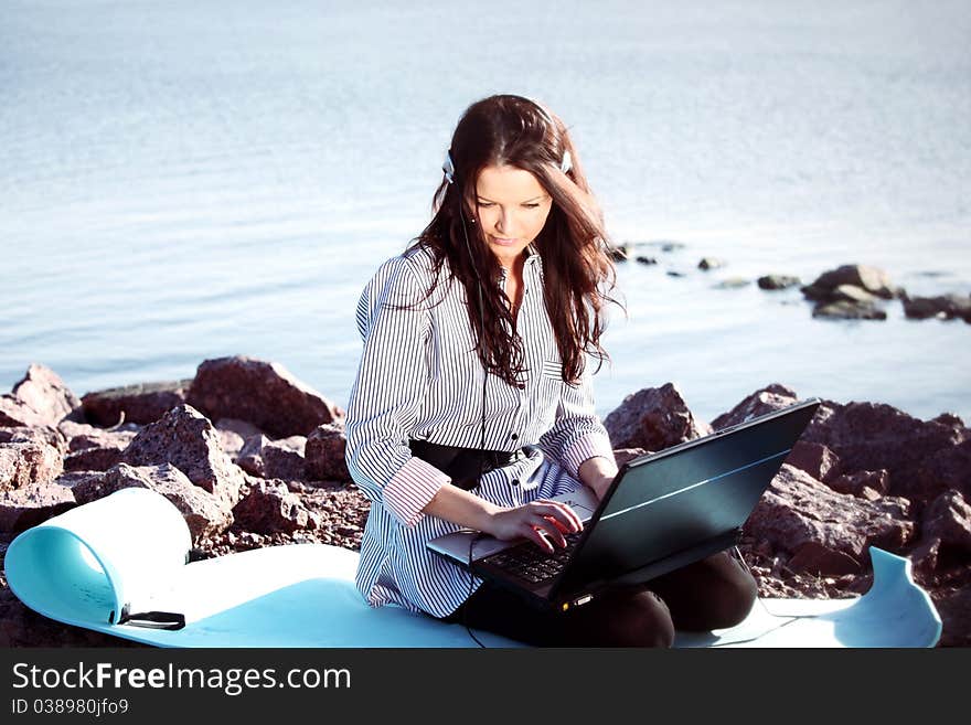 Woman work on laptop sea on background. Woman work on laptop sea on background