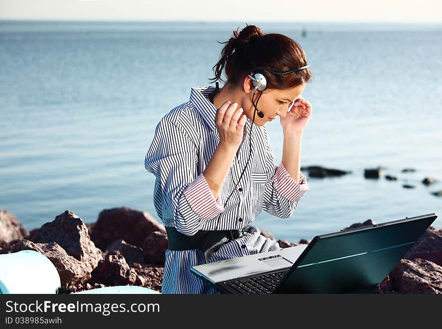 Woman work on laptop sea on background. Woman work on laptop sea on background