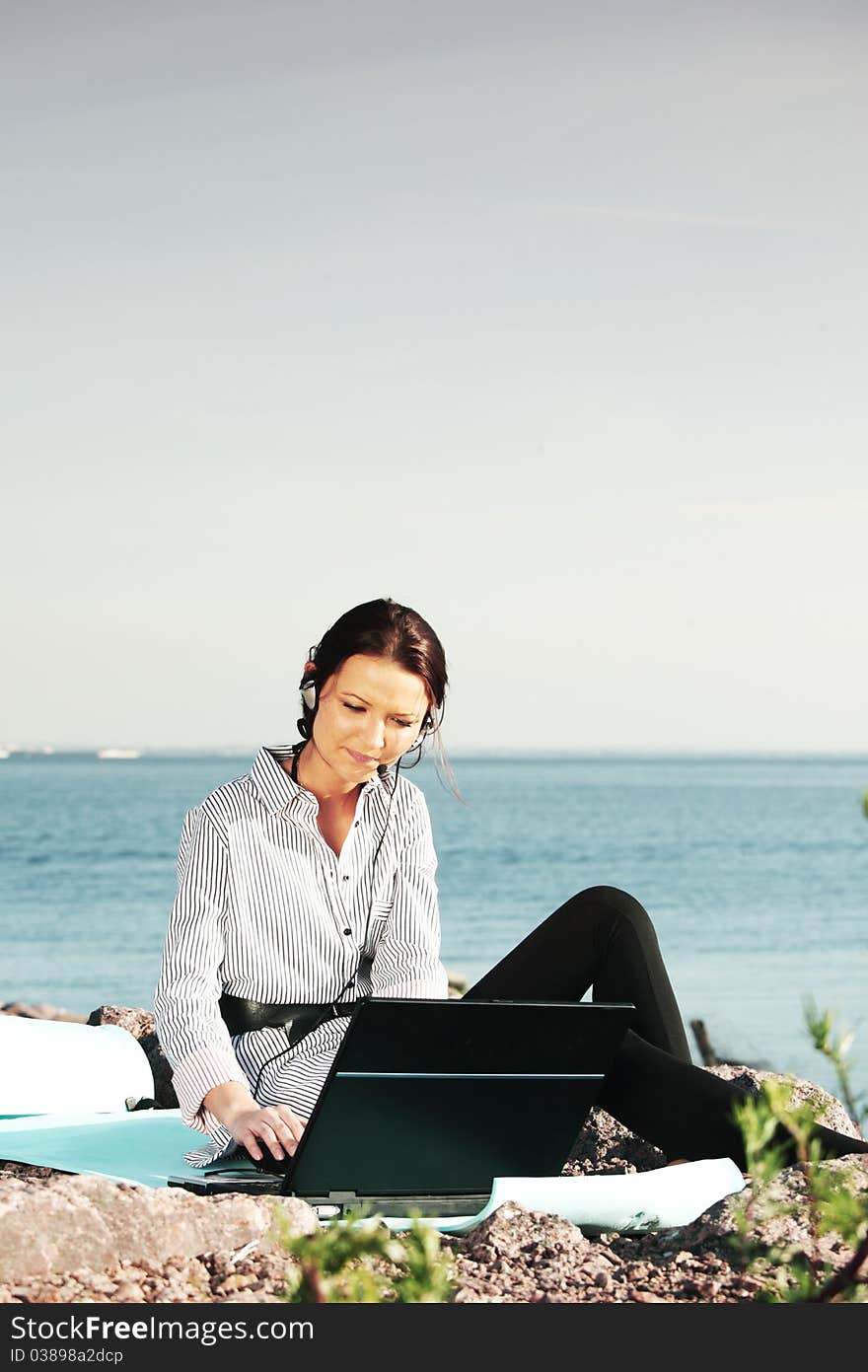 Woman work on laptop sea on background. Woman work on laptop sea on background