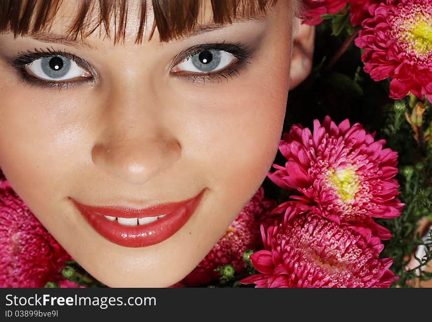 Portrait of a young woman with pink flowers. Portrait of a young woman with pink flowers