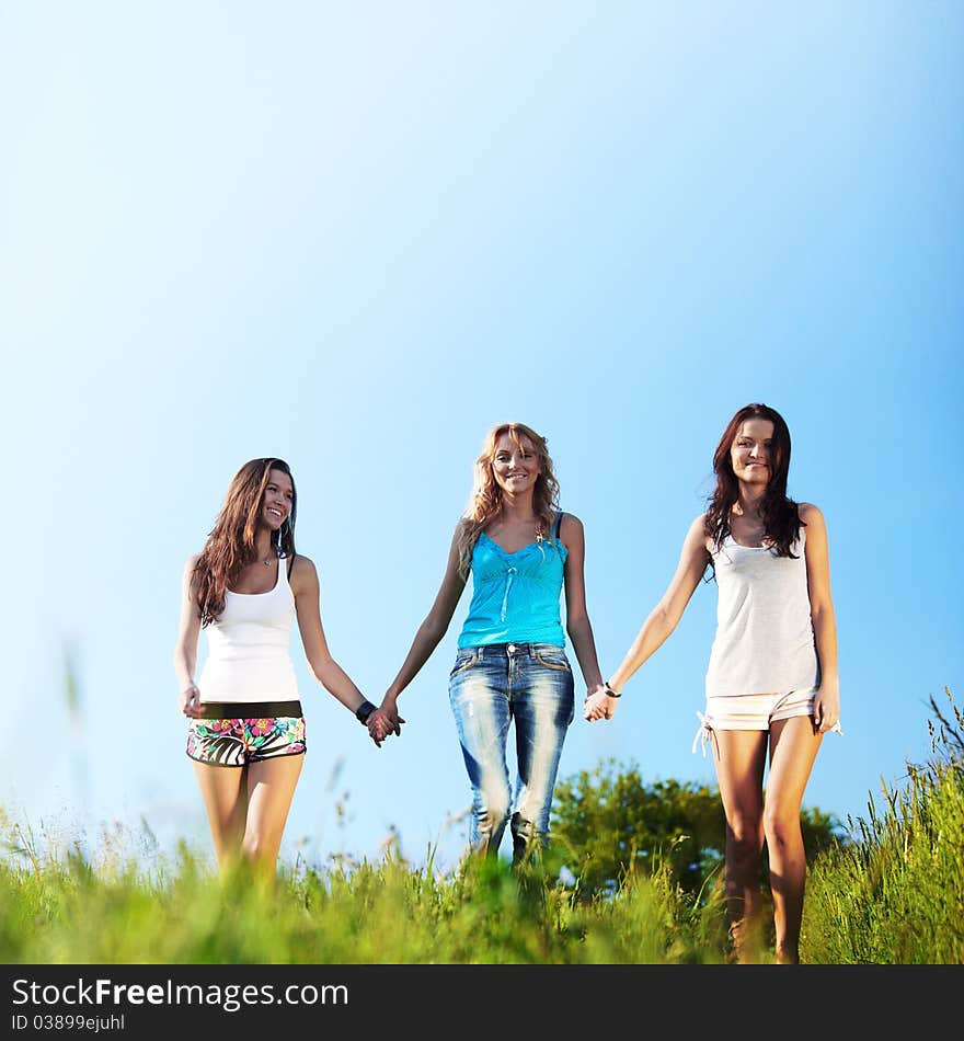 Fun smile girlfriends run by green field sun is shine. Fun smile girlfriends run by green field sun is shine