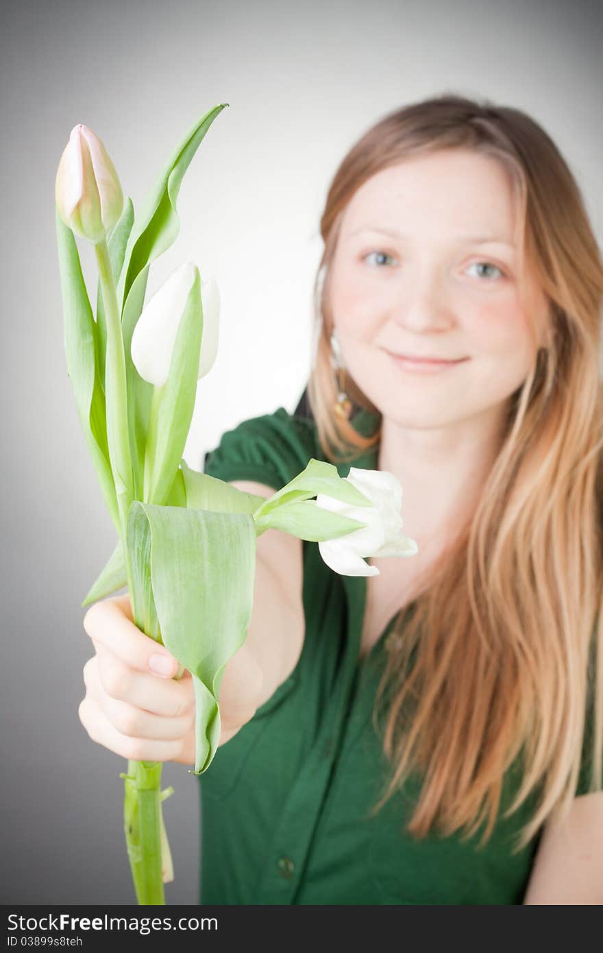 Young girl with tulips, with grey background. Young girl with tulips, with grey background