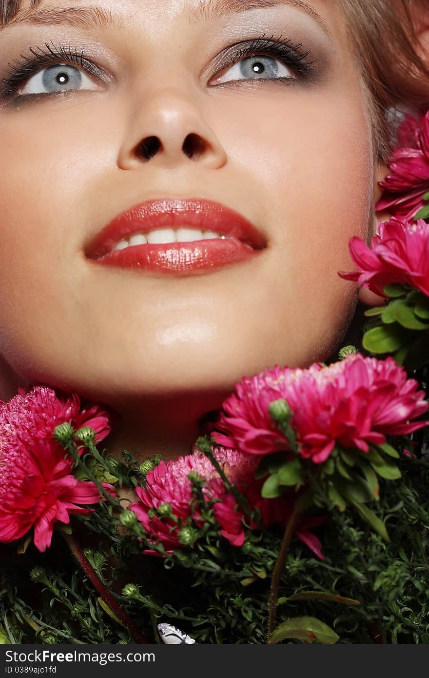 Portrait of a young woman with pink flowers. Portrait of a young woman with pink flowers