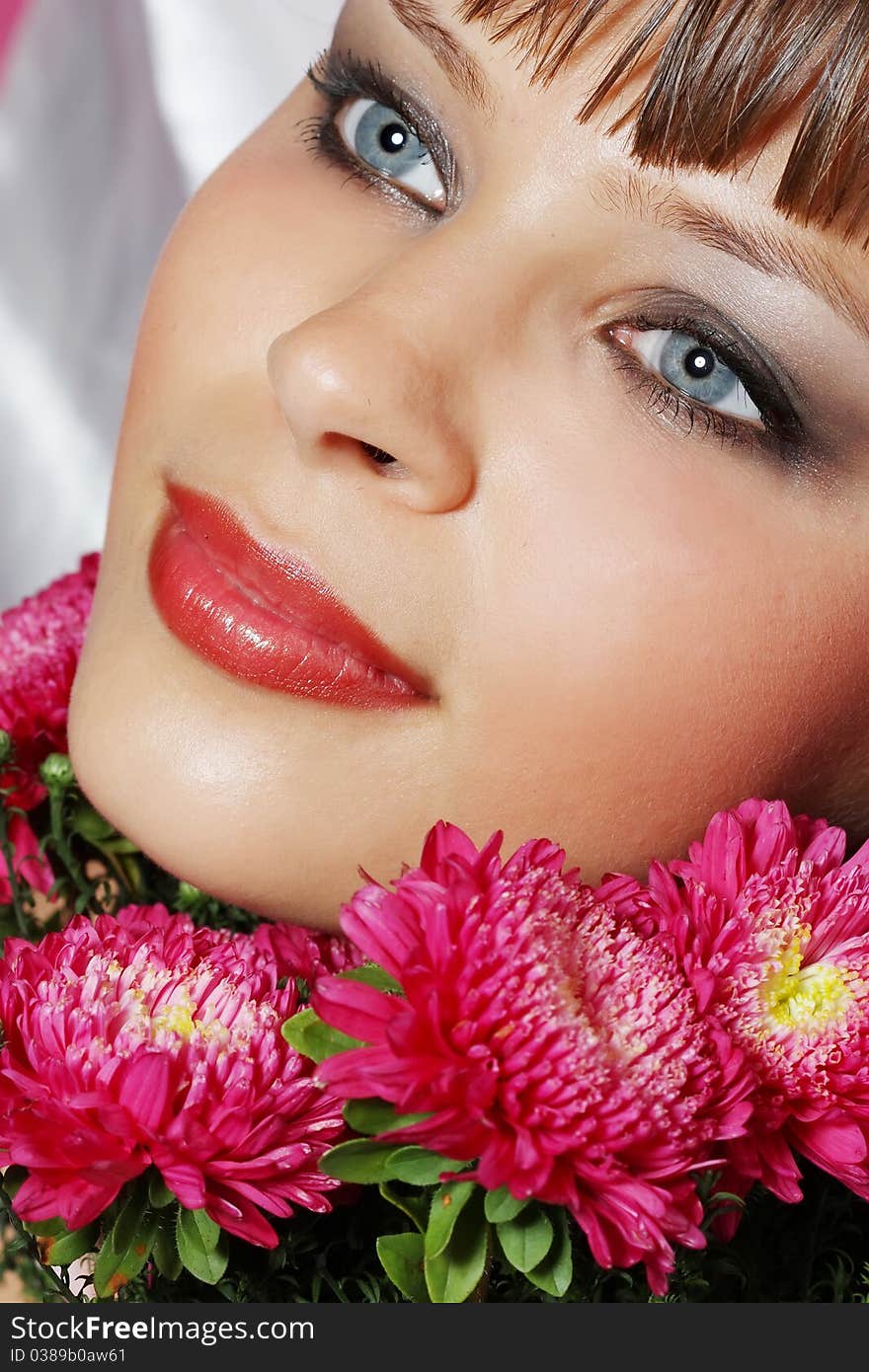 Portrait of a young woman with pink flowers. Portrait of a young woman with pink flowers